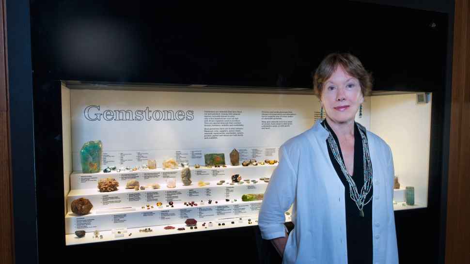 Gayle Sutherland in front of gem display